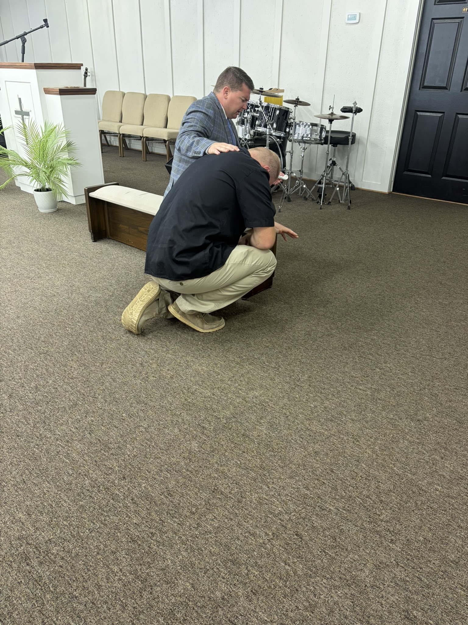 Pastor praying with a church member
